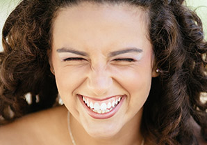 girl with eyes closed, laughing