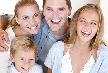 parents and kids looking up, smiling