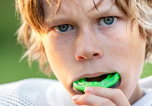 A teenager with blond hair putting in an athletic guard