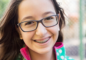 girl wearing traditional braces for straight teeth