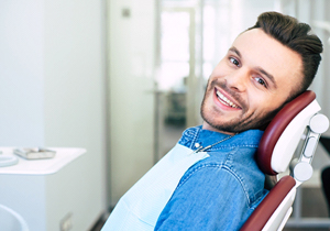 Smiling man in a blue shirt getting a checkup