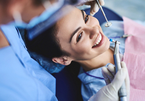 Woman with brown hair getting a dental checkup and cleaning