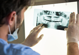 dentist looking at a dental x-ray