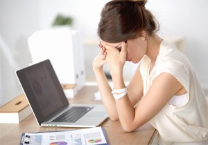 Woman experiencing fatigue at work.