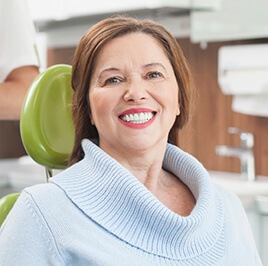 woman in a blue sweater, smiling