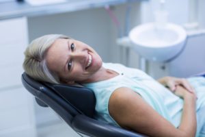 Smiling woman in dental chair.