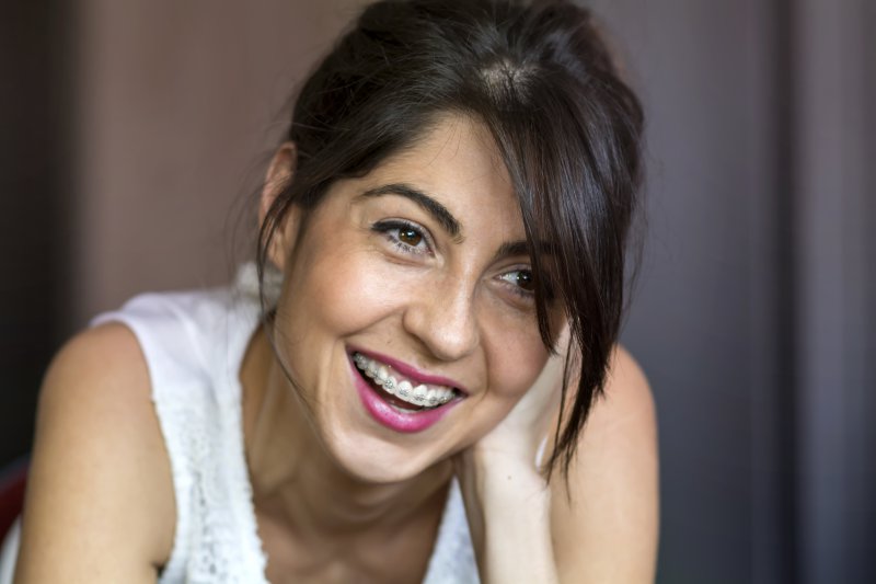 Woman with braces smiling.