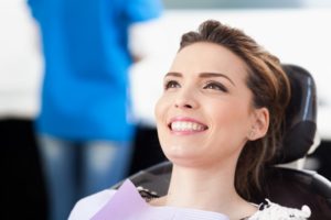 Woman with beautiful smile in the dental chair.