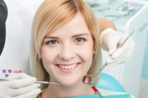 Smiling woman in dental chair. 